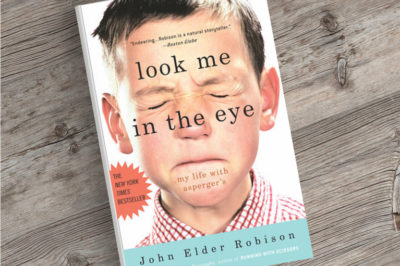 An image of the novel Look Me In The Eye on a desk.